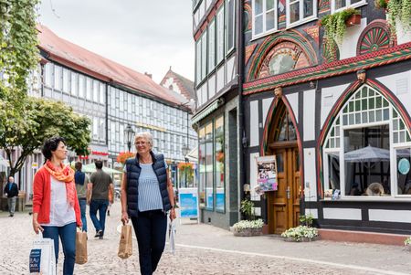 Bummeln im Fachwerk Zwei fröhliche Menschen schlendern über den Einbecker Marktplatz.